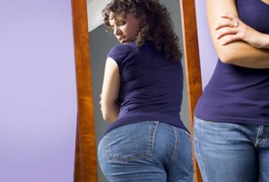 getty_rf_woman_looking_at_rear_in_mirror