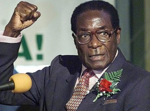 Zimababwe's President Robert Mugabe chants Zanu PF slogans with supporters gathered at the Harare International Conference Centre in Harare, Wednesday May 3, 2000. Mugabe launched the Zanu PF's election manifesto which bears the slogan "Land is the Economy and the Economy is Land". (AP Photo/Christine Nesbitt)